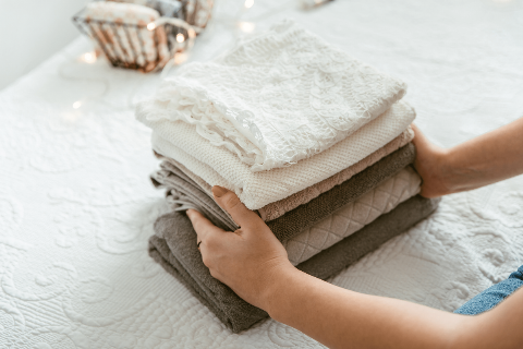 Folding a pile of clothes.