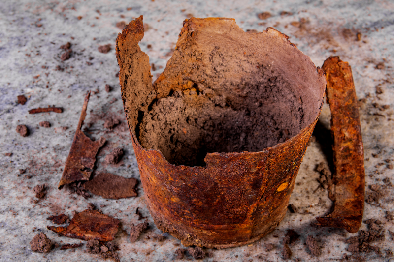 A rusty pot falling apart.