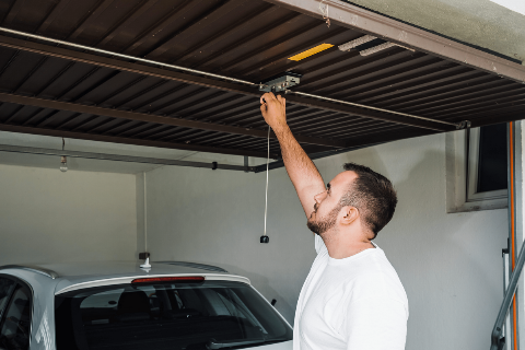 A person closing a garage door.