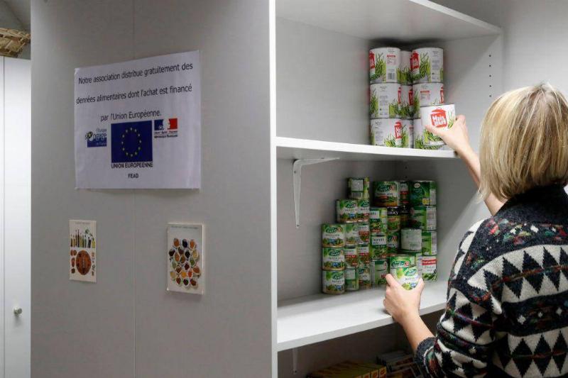 Woman stocking canned food on flights.