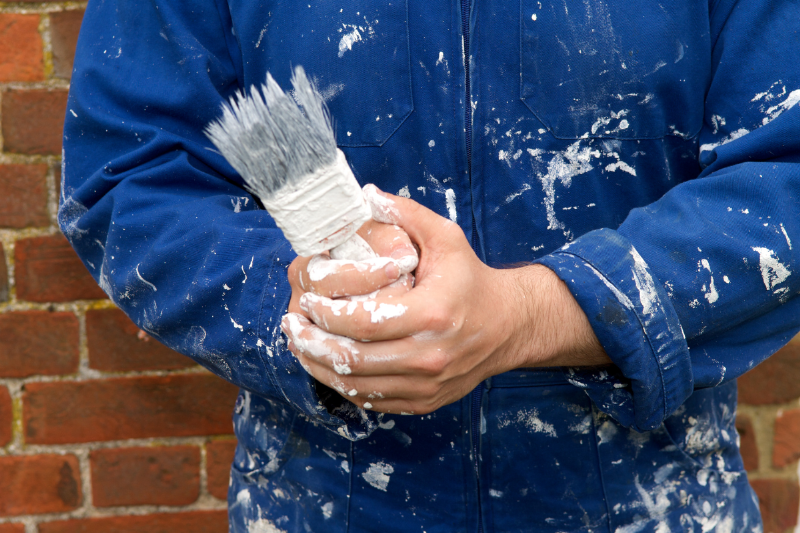 Person holding paint brush.