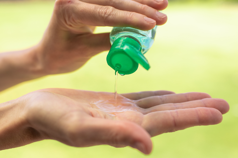 Pouring hand sanitizer.