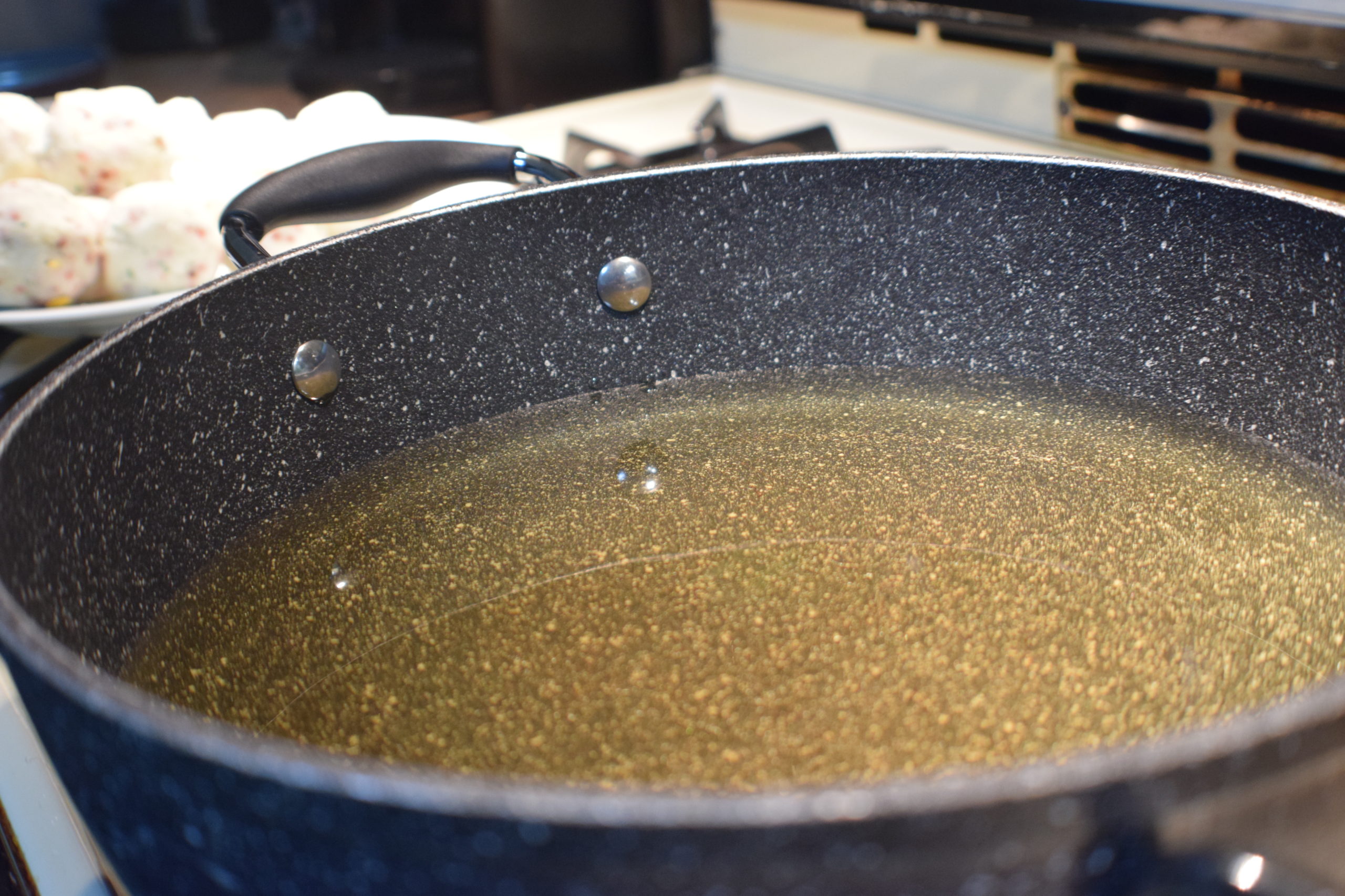 black stone pan filled with hot oil on stove