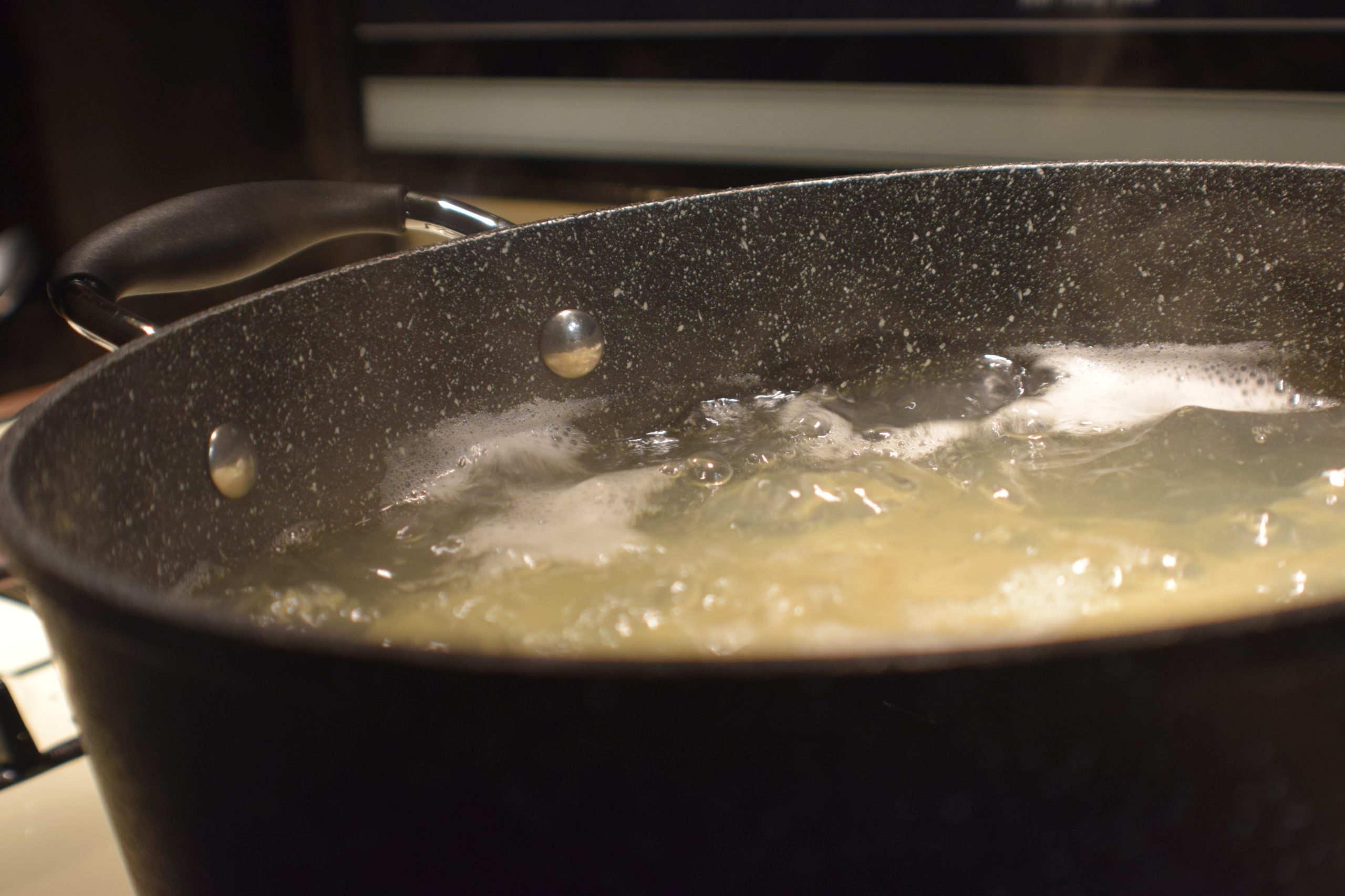 boiling water in black stone pot