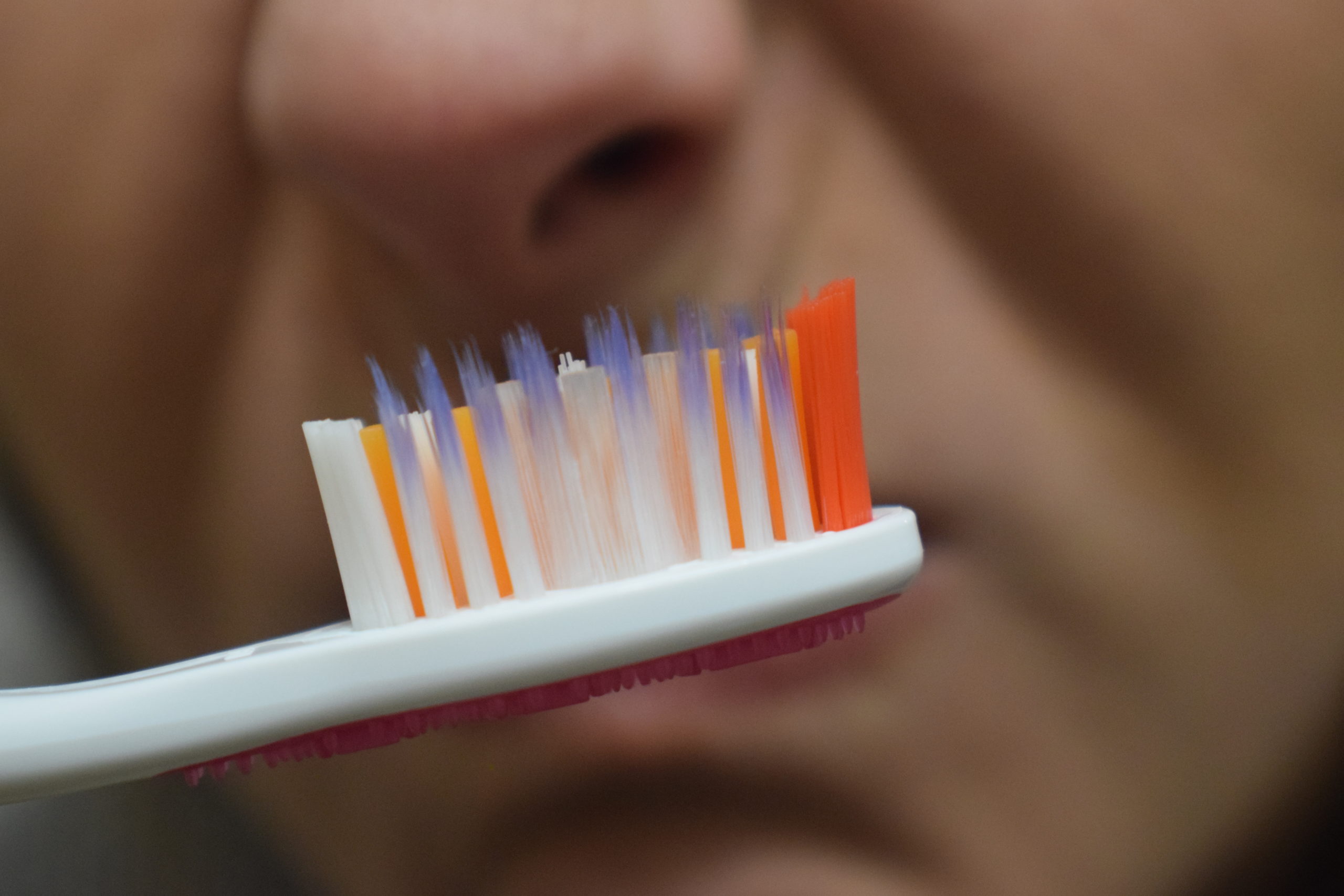 nose smelling a smelly toothbrush