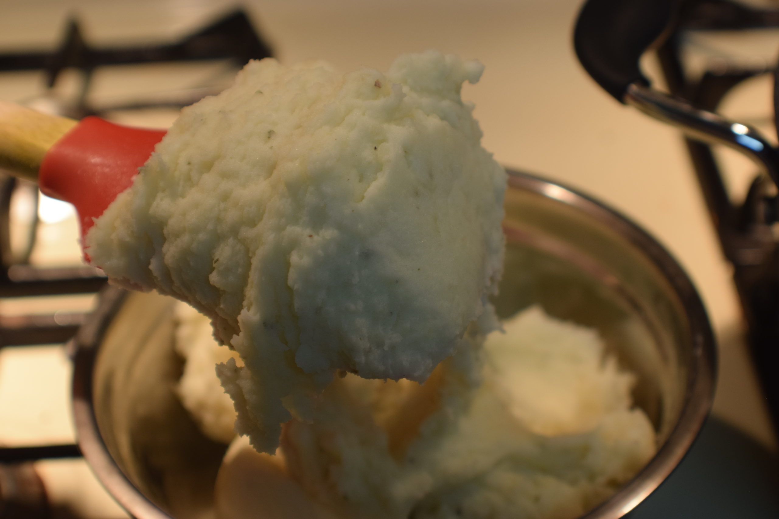 Mashed potatoes on red spoon