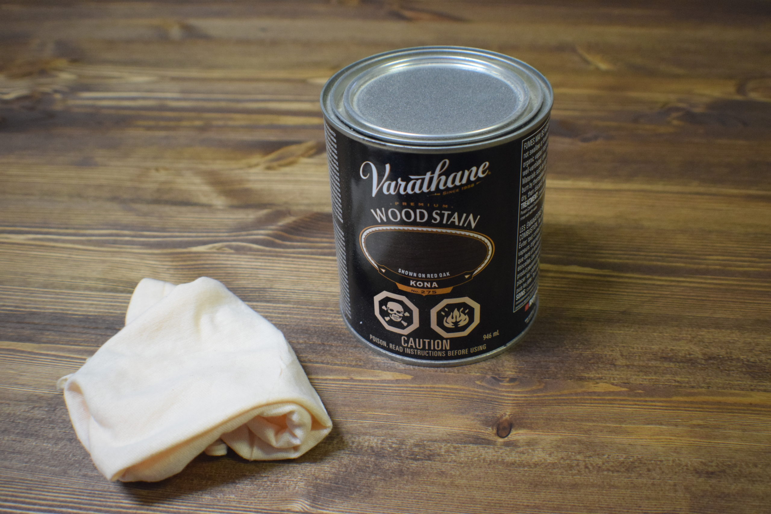 can of varathane premium wood stain with black label on wood table with rag