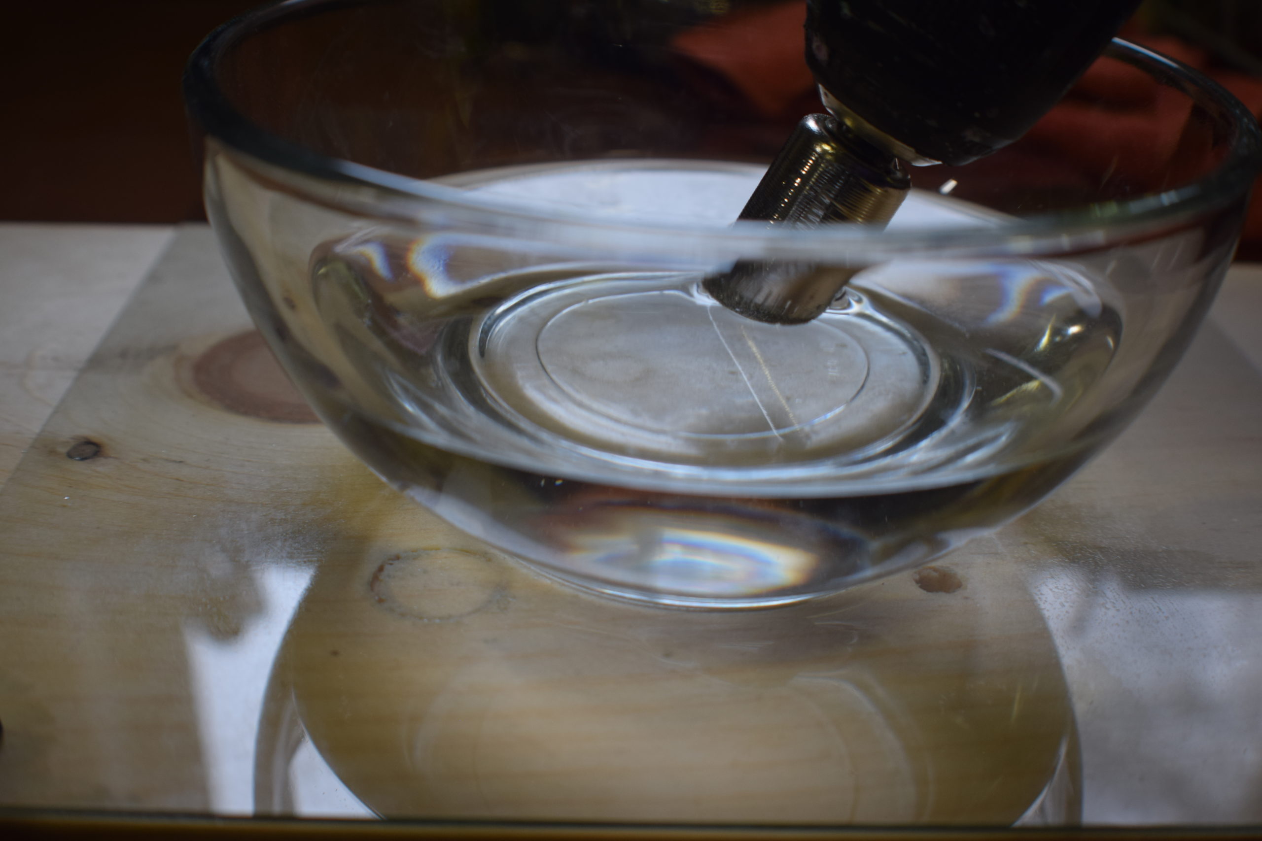 rinsing diamond drill bit in a dish of water