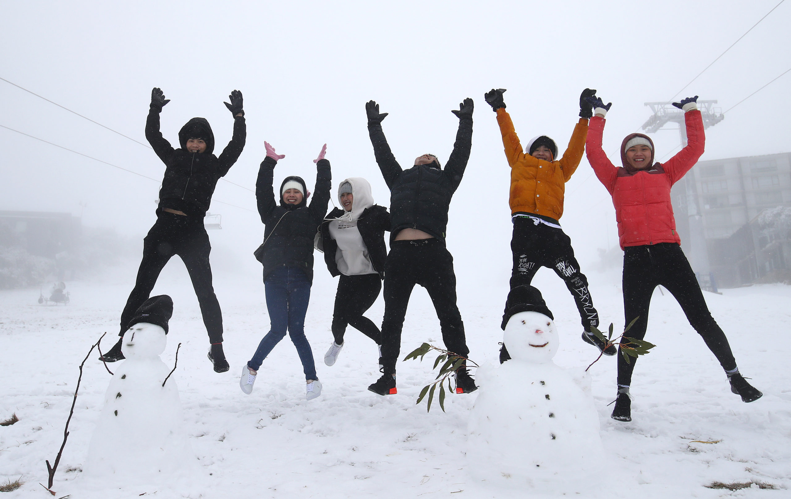 group of skiers jumping in air