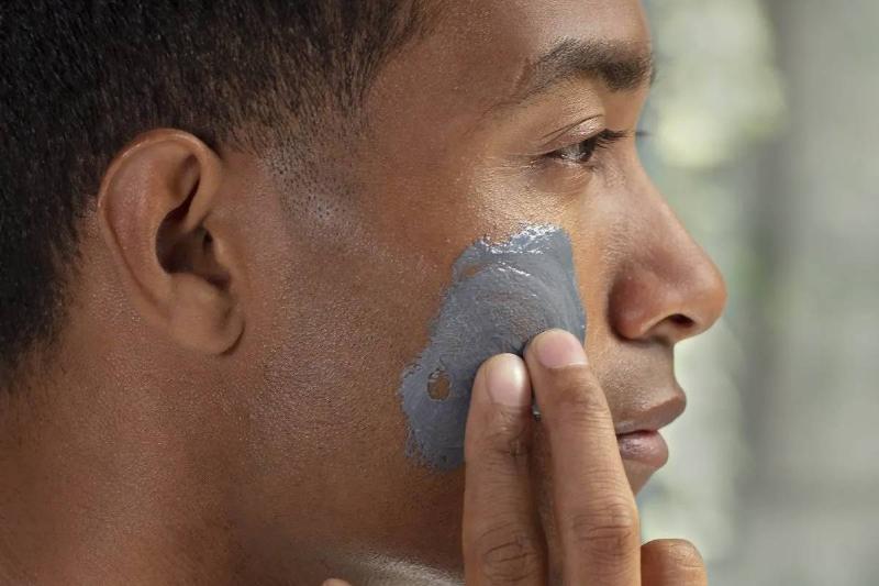 Man rubbing product into skin