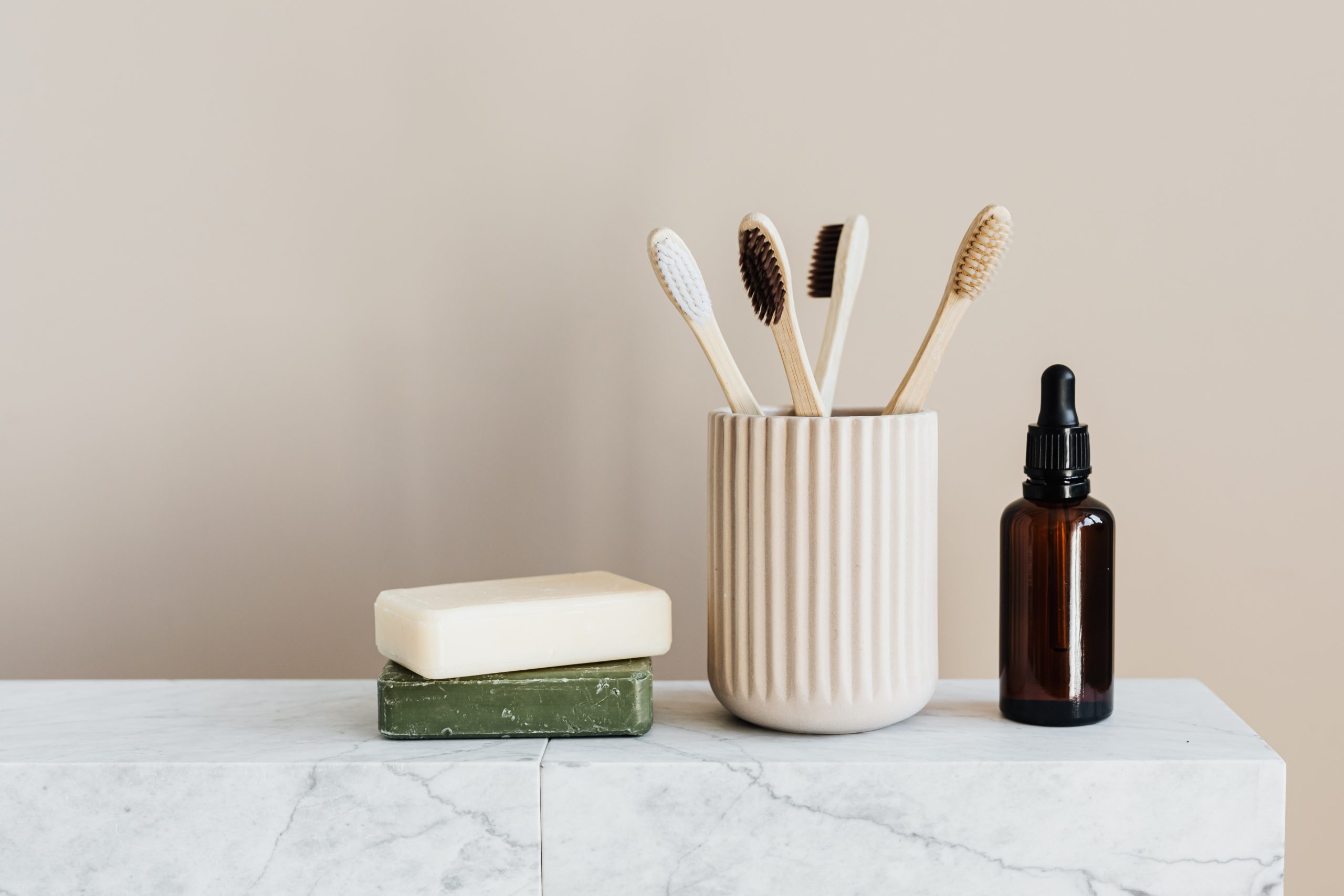 toothbrushes air drying in masculine bathroom with soap and oil