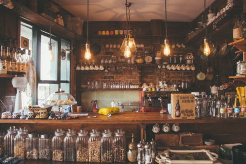 rustic home bar with soft lit pendant lights and serval ingredients