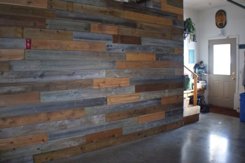 relaimed wood wall with multi colored boards
