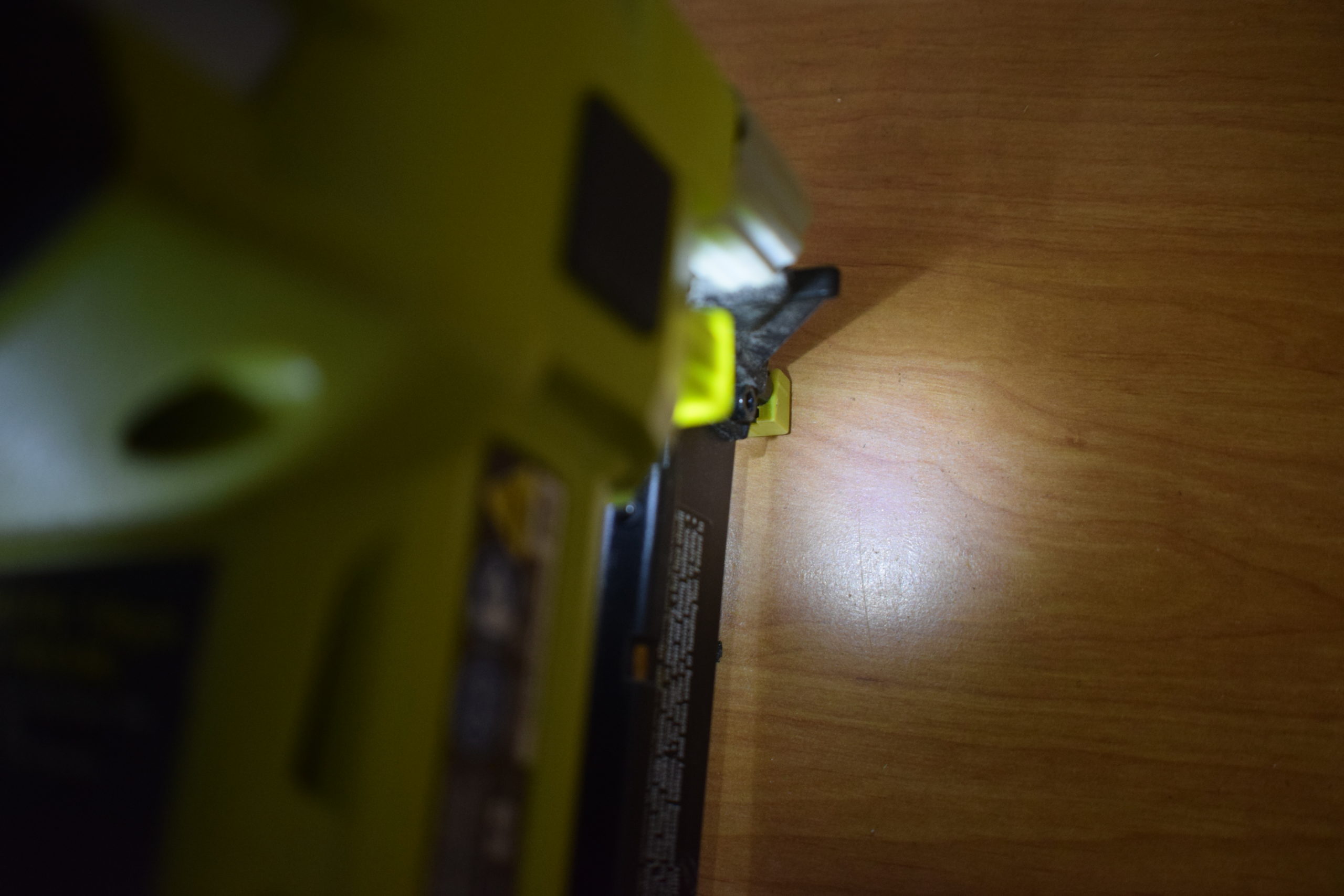 grip light on ryobi airstrike nail gun reflecting off wood