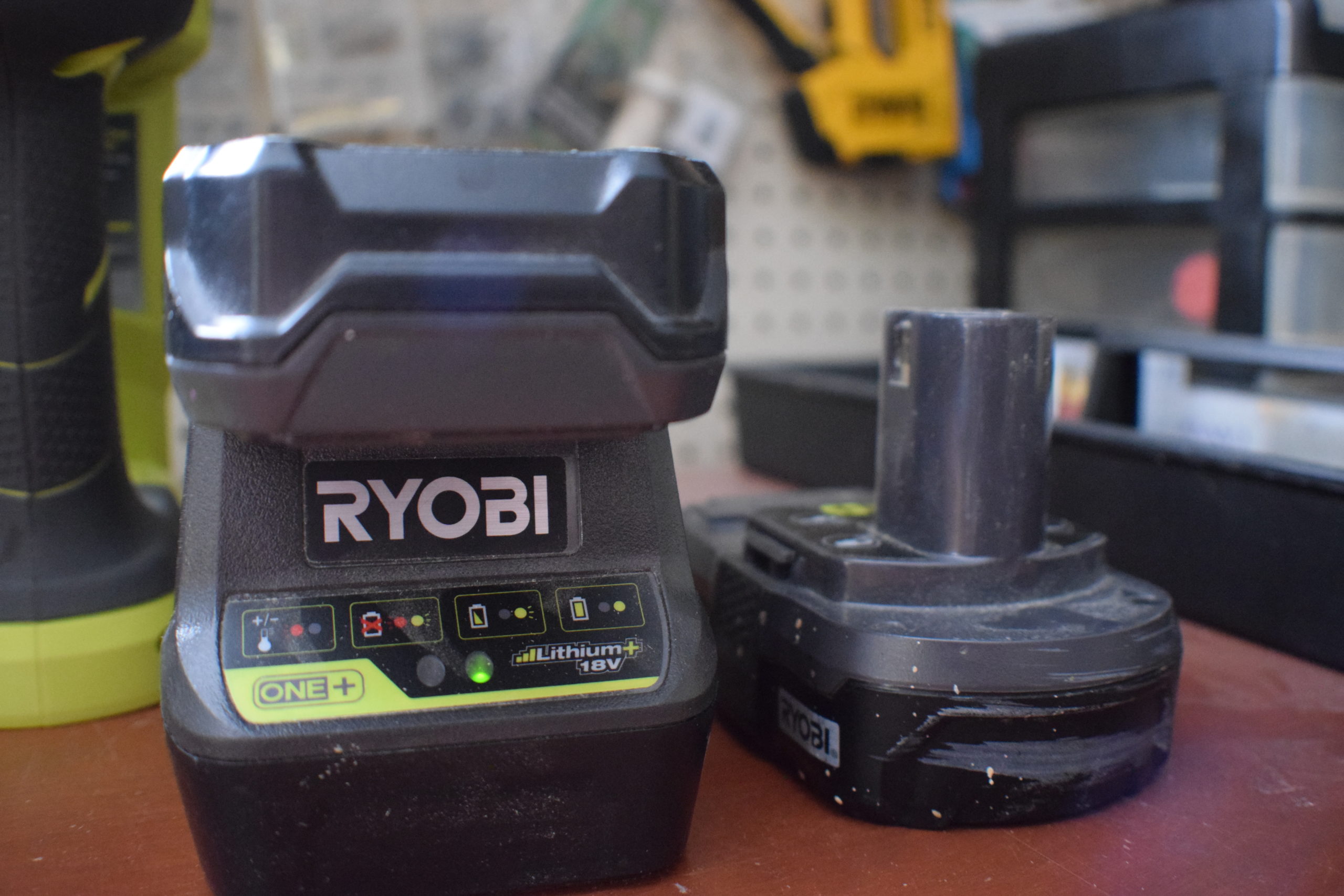 ryobi battery charger and 2 batteries in a workshop