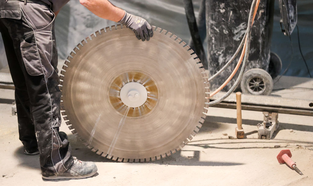 worker holding a concrete saw