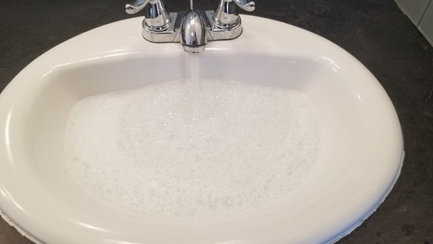 sink filled with soapy water