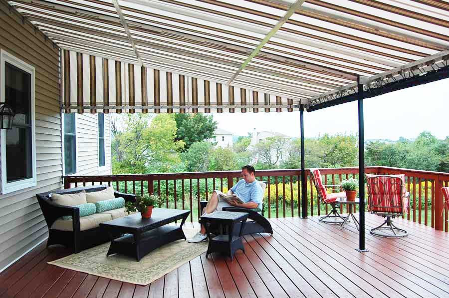 Man sitting and reading a book in the patio