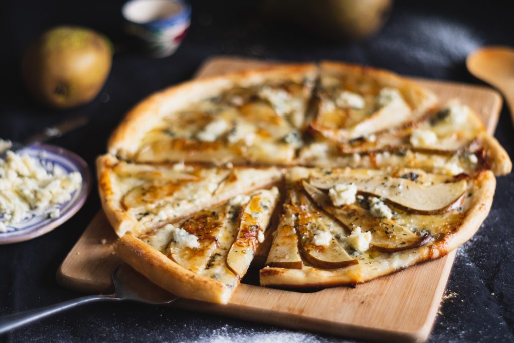 cheese pizza with feta cheese and pear slices