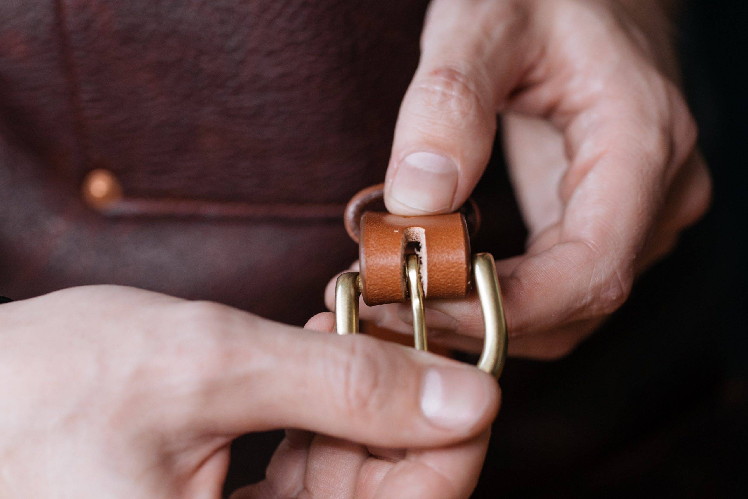 Hands holding belt buckle