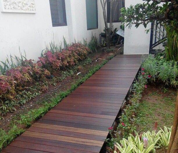wooden boardwalk in backyard garden