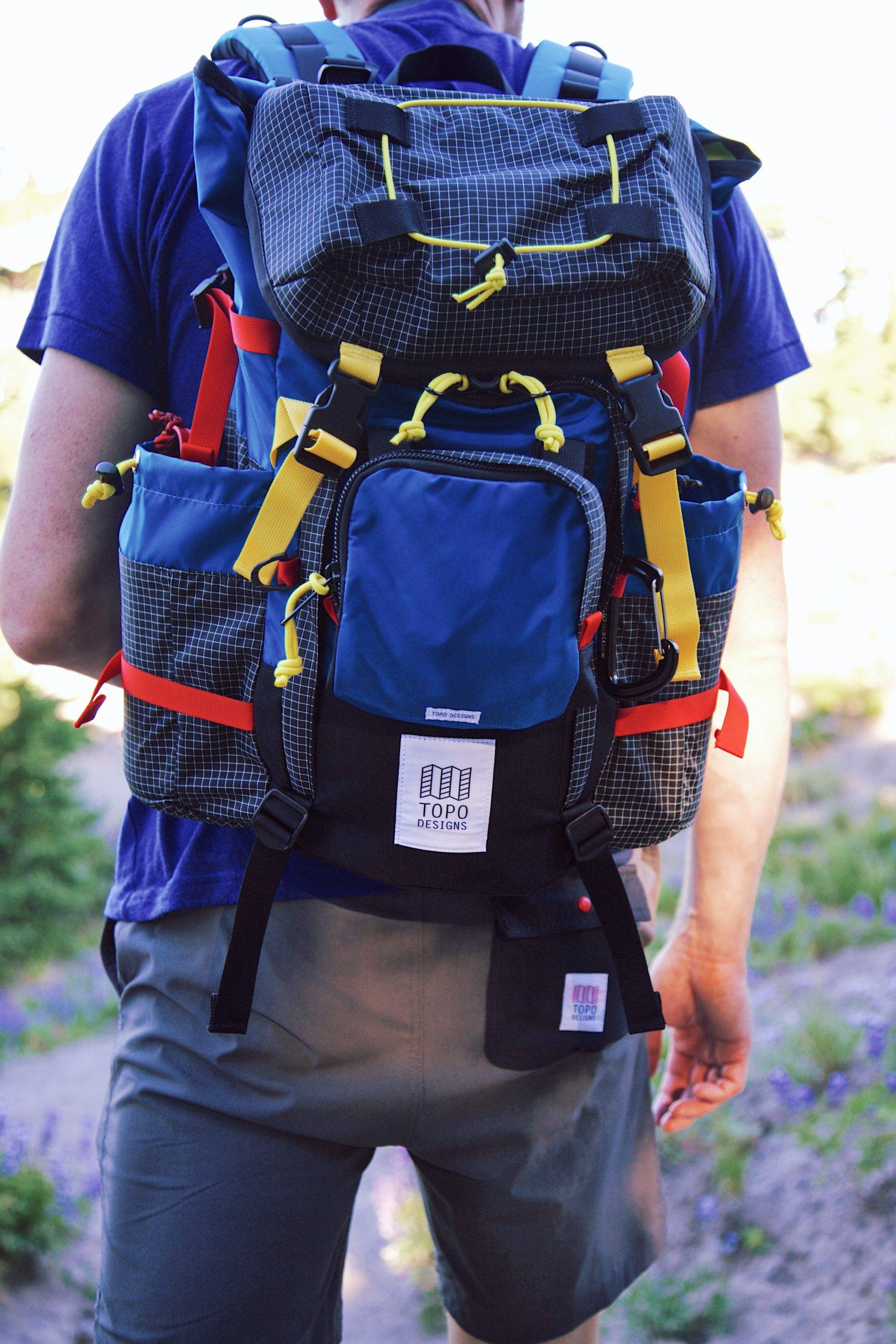 Blue backpack behind a man wearing blue shirt