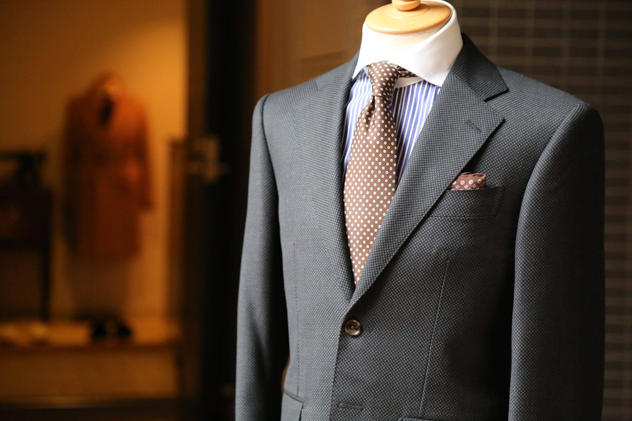 Grey suit with brown polka dots tie