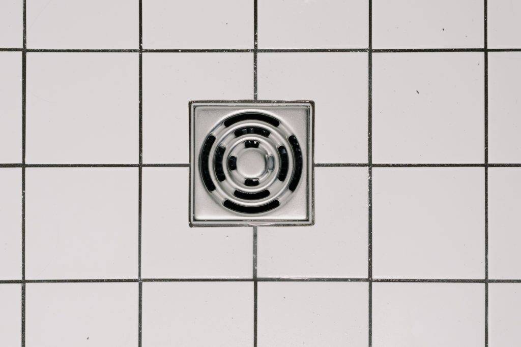 shower drain on white tile floor