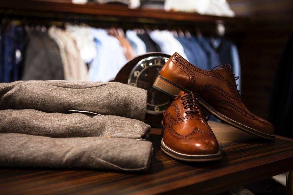 men's leather shoes next to clothing