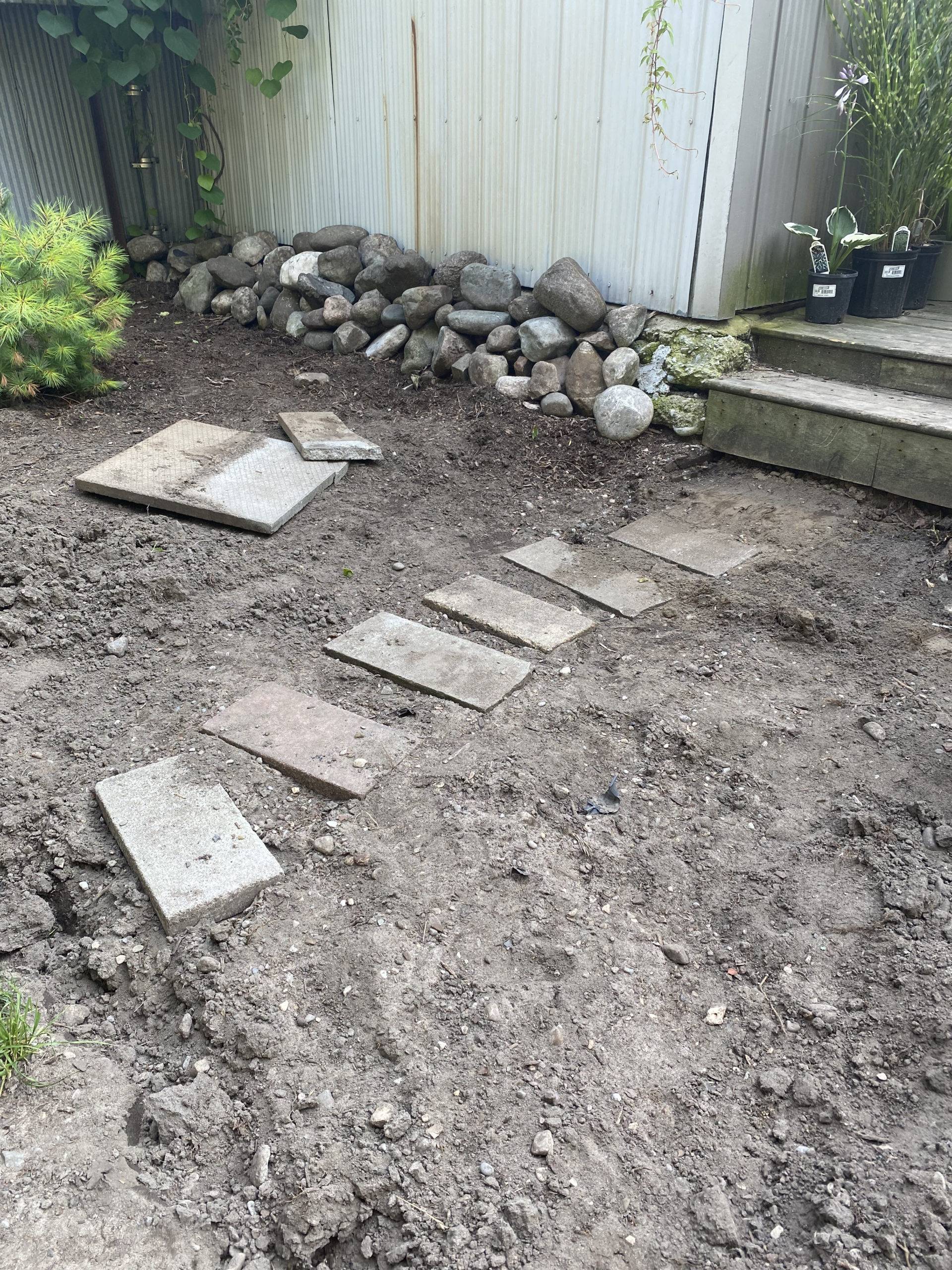 stones in dirt before boardwalk