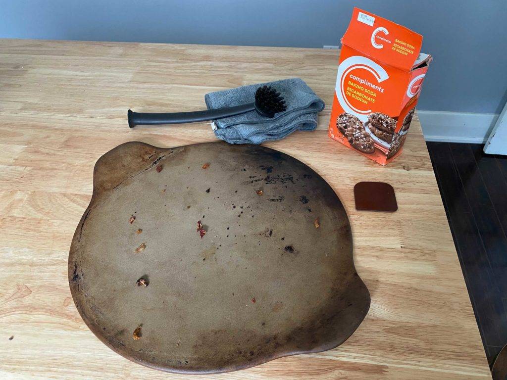 pizza stone with cleaning supplies
