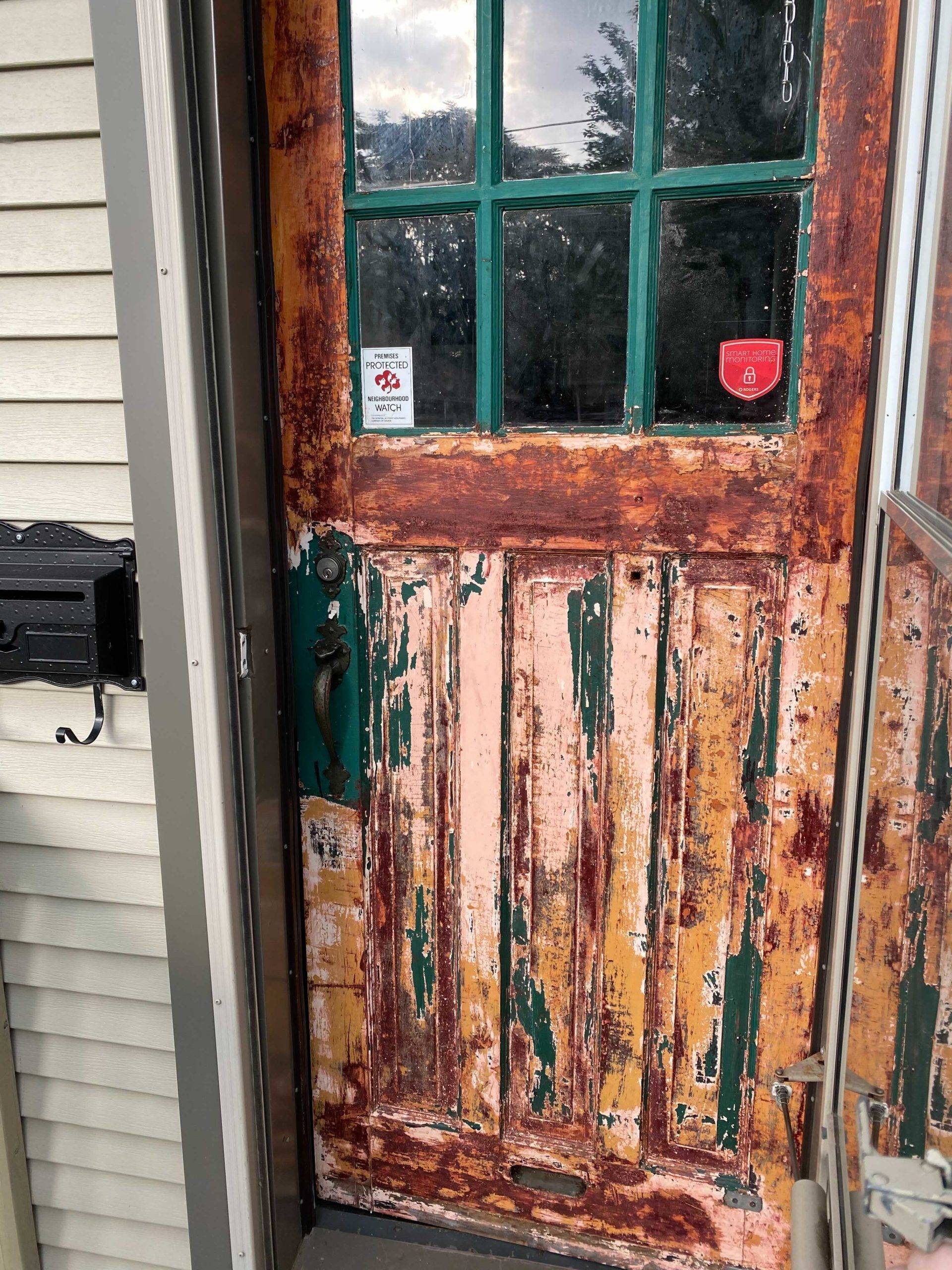 wood door with multiple coats of paint on it