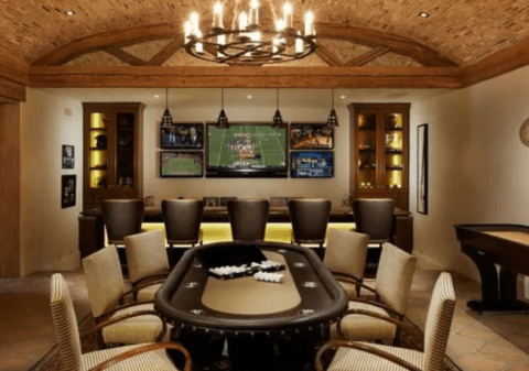 man cave with poker table and chandelier