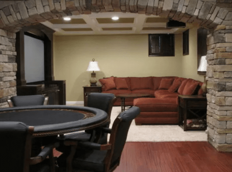 man cave with poker table and stone arch opening