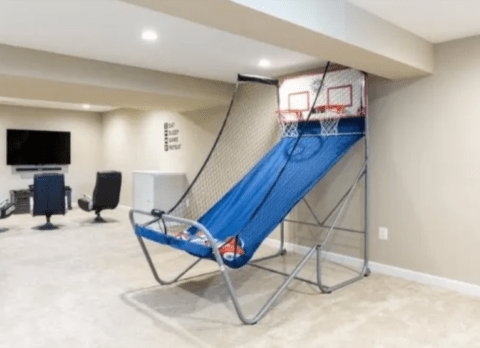 basement man cave with basketball shooting game