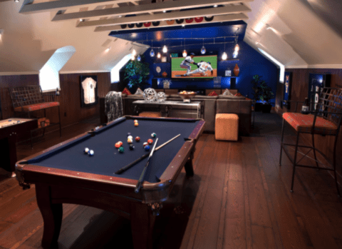 sports themed man cave with pool table