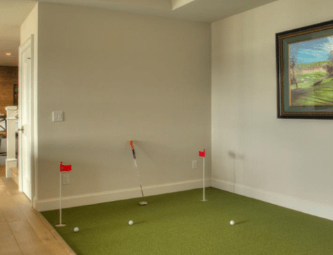 man cave with putting green corner