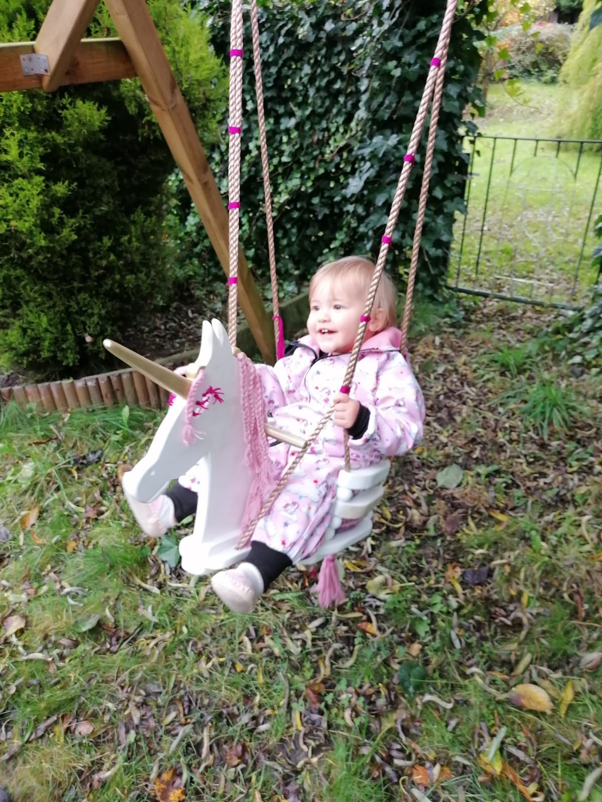 child on unicorn swing