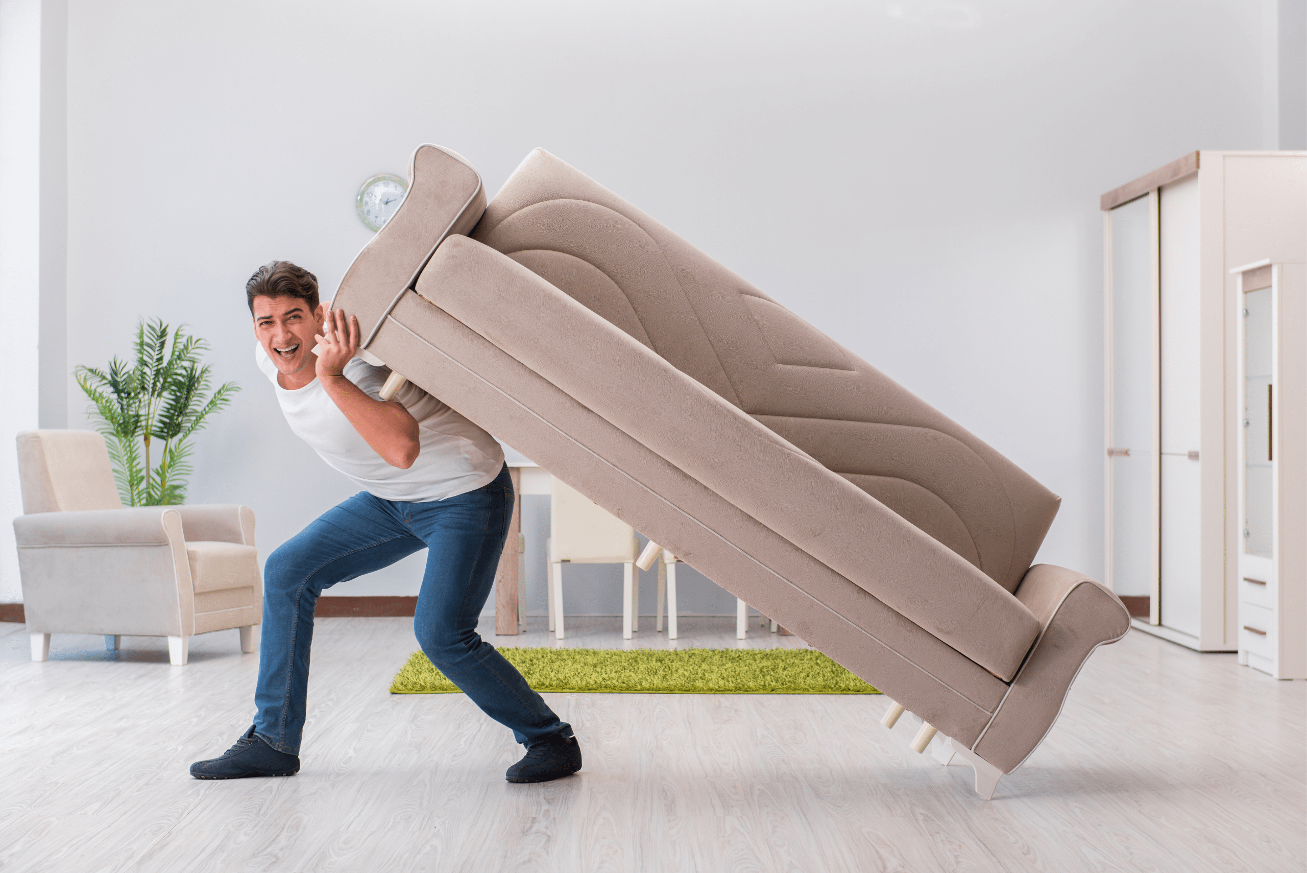 Man lifting up a side of a couch.