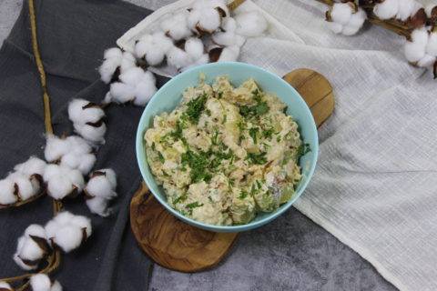 potato salad garnished with parsley in blue bowl