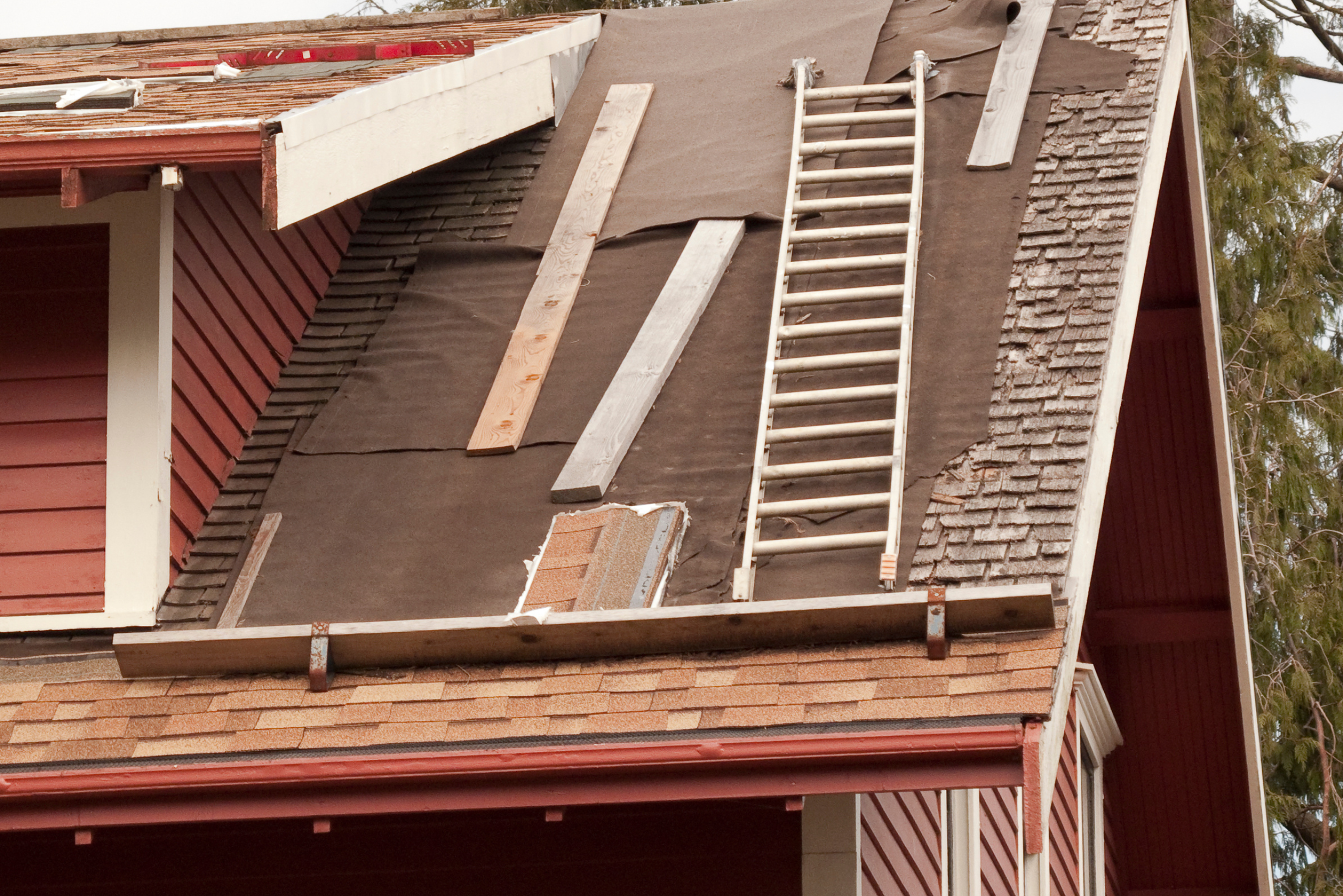 Ladder on the roof of a house.