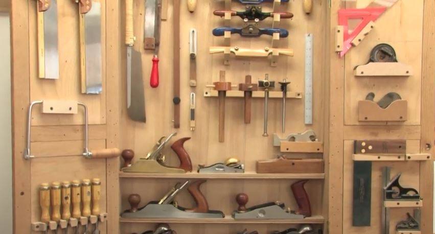 hanging tool cabinet filled with tools
