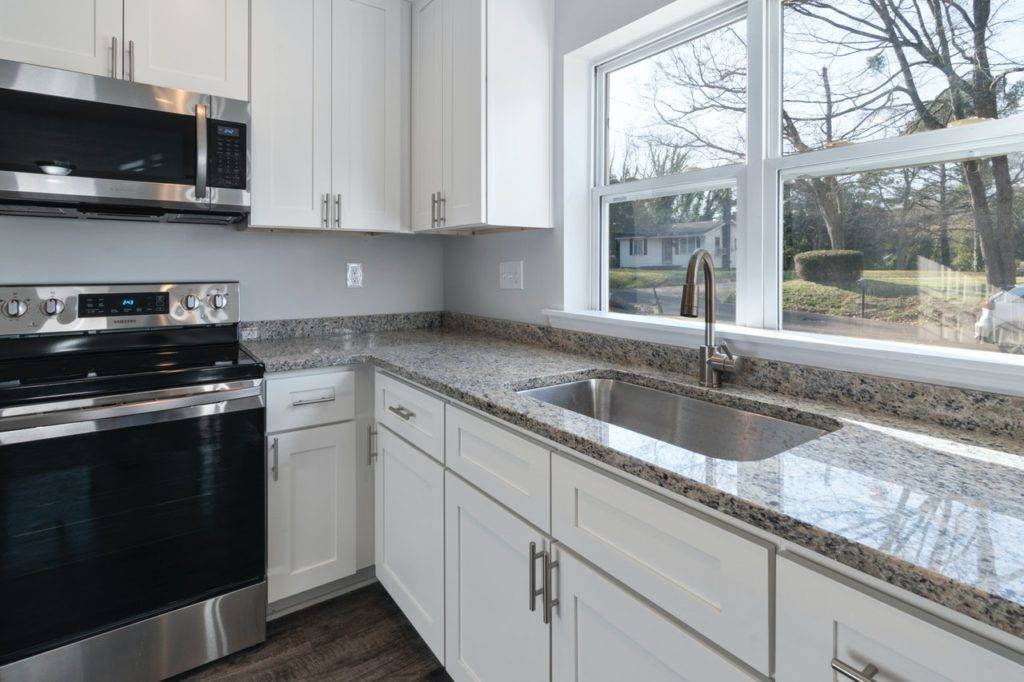 white kitchen cabinets with granite countertops