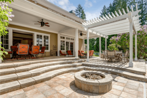 backyard patio stone red chairs fan fire pit