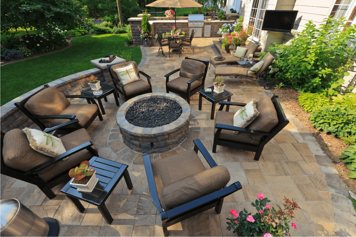 fire pit on stone patio with chairs around