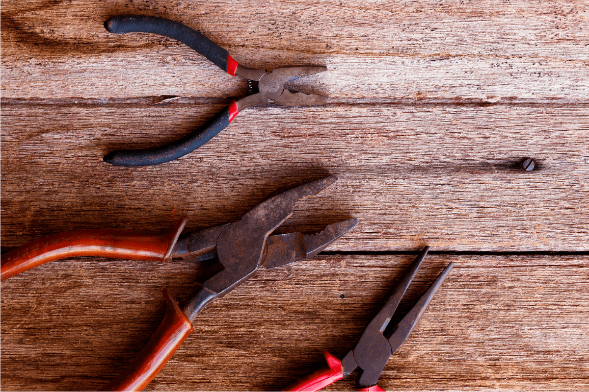 pliers on wood background