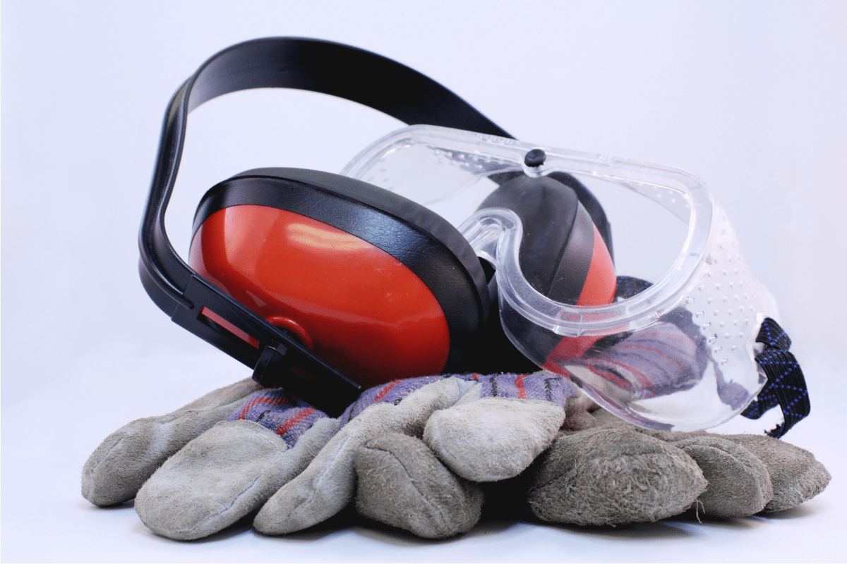 ear protection safety glasses and work gloved on white background