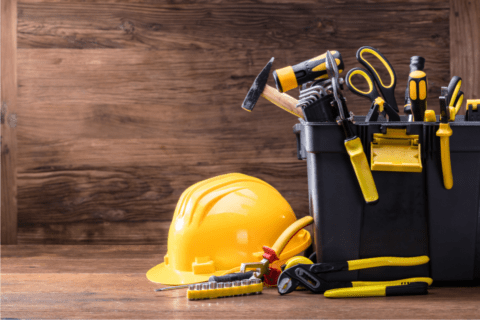 blank and yellow tools wood background