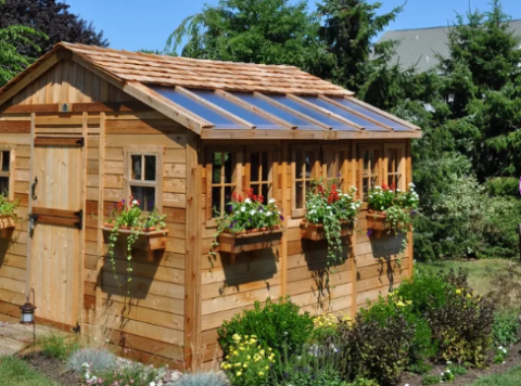 Cedar shed that has flowers by windows and a transparent half roof.