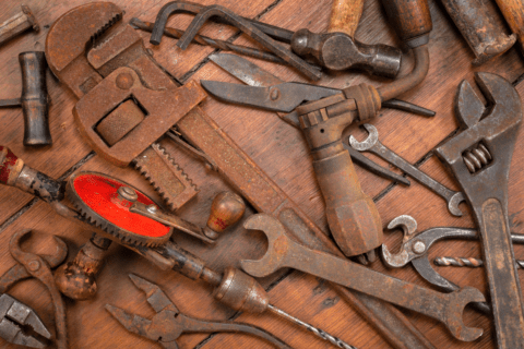old rusty tools laying on wooden background
